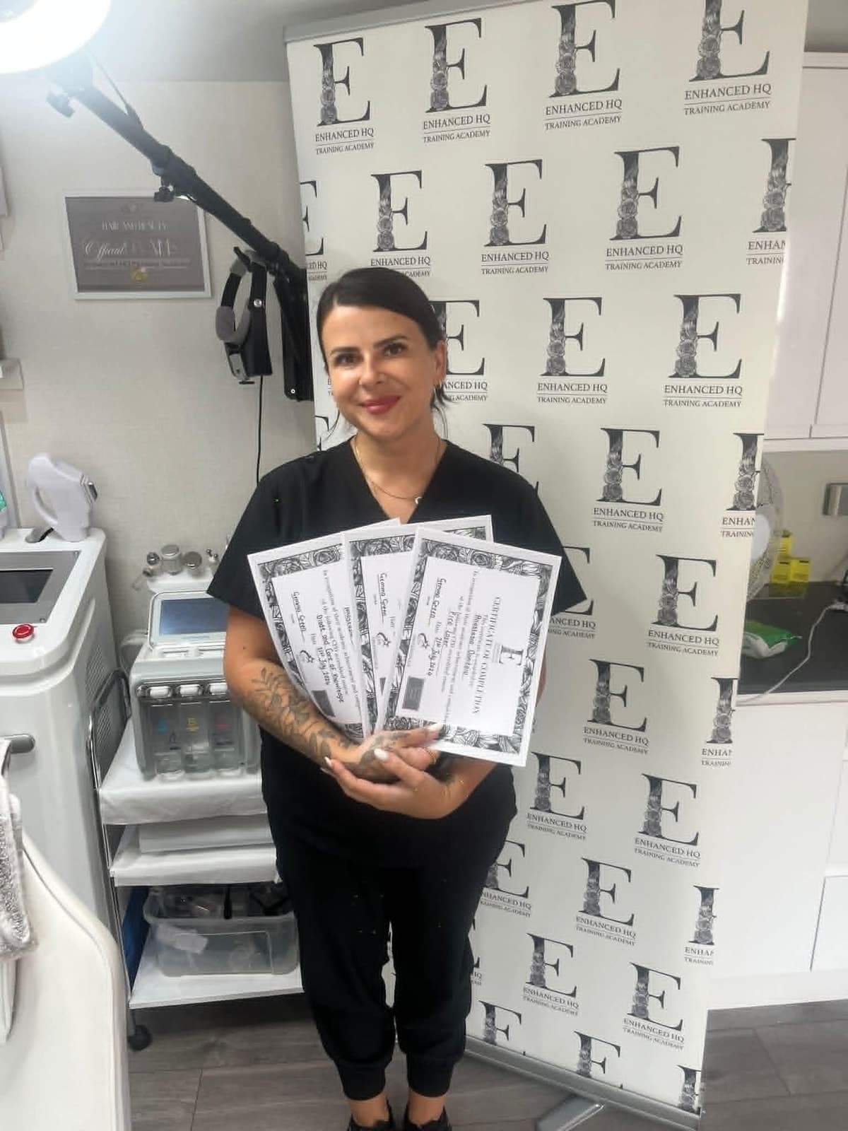 Anastasia holding her completed course certificates